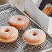 A tray of Pillsbury yeast-raised donuts with powdered sugar on top.
