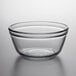 An Anchor Hocking clear glass mixing bowl on a white surface.