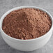 A bowl of Gold Medal Devil's Food Cake Mix, a brown powder.