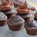 A group of Pillsbury Double Dark Chocolate muffins on a cooling rack.