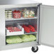 A Traulsen undercounter refrigerator with food inside.