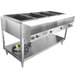 A Vollrath commercial stainless steel hot food warmer with four pans on a counter.