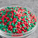 A bowl of red and green sprinkles.