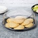 A WNA Comet black round catering tray with a plate of cookies and celery.