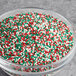 A bowl of Christmas nonpareil mix with red, green, and white candy sprinkles.