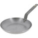 A de Buyer carbon steel frying pan with a handle.