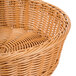 A honey round plastic basket with a woven design.