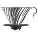 A silver stainless steel Hario V60 coffee dripper with a black rubber base.