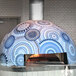 A Wood Stone Traditional Series stone hearth pizza oven with a blue and white circular design.