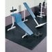 A weight bench and weights on a black rubber Cactus Mat tile.