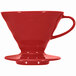 A red Hario V60 coffee dripper on a white surface.