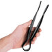 A person holding a pair of black Thunder Group flat grip tongs.