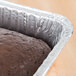 A chocolate cake in a Durable Packaging foil cake pan.