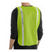 A man wearing a Lavex lime green safety vest with reflective stripes.