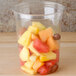 A Bare by Solo clear plastic deli container filled with fruit.