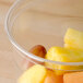 A clear Bare by Solo deli container filled with fruit.