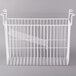 A white wire basket with a handle hanging inside a white freezer.