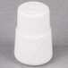 A white porcelain salt shaker with a lid.