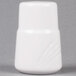 A CAC white porcelain salt shaker with a lid.