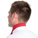 The back of a man with short brown hair wearing a red chef neckerchief over a white shirt.