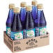 A group of Rose's Blueberry Syrup bottles in a cardboard box.