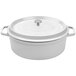 A white oval Dutch oven with a lid.