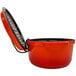 A red and black pot with a lid in a GET Heiss Lid Holder.
