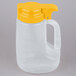 A white plastic jug with a yellow lid and handle.