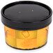 A yellow and black Huhtamaki paper soup container with a black lid.