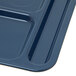 A dark blue Carlisle tray with four compartments.