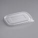 A rectangular clear plastic PET lid on a gray surface.
