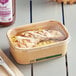 A rectangular EcoChoice take-out lid on a container with chicken and rice.