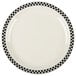 A creamy white China plate with black and white checkered trim.