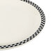 A white Homer Laughlin china plate with black and white checkered trim.