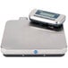 An Edlund stainless steel digital pizza scale on a counter.