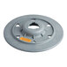 A grey plastic disc with an orange center and a hole, with a yellow label on the grey part.