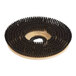 A circular Lavex scrub brush with black bristles.