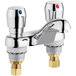 Two Chicago Faucets deck-mounted metering faucets with chrome finish.