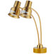 A gold Avantco dual arm heat lamp with two yellow shades.