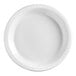 A Huhtamaki Chinet white plastic plate with a circular edge and a small design on the border.