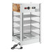 A white and silver ServIt countertop display warmer with wire shelves.