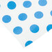 A white paper table cover with blue polka dots.