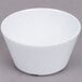 A white Thunder Group Nustone melamine bouillon bowl on a gray surface.