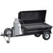 A black trailer with a gas cylinder attached to a large black barbecue grill.