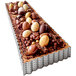 A rectangular tart with chocolate and chocolate crumbles on top baked in a de Buyer rectangular fluted tart ring.