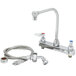 A T&S chrome deck-mount faucet with hose and 48" sprayer.