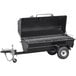 A black barbecue grill with a trailer attached.
