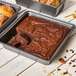 A de Buyer square cake pan with brownies in it.