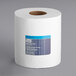 A white roll of Tork Advanced paper towels with blue stripes.