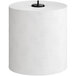A Tork white paper towel roll with grey leaf pattern on the packaging.